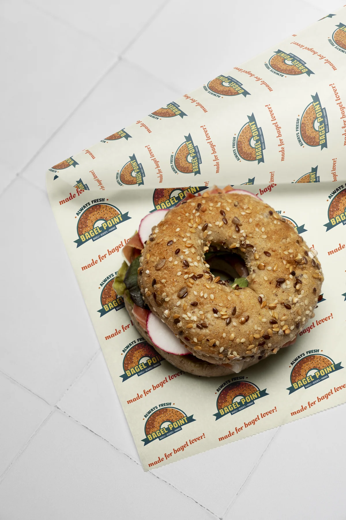 Tiled wax wrap pattern under a bagel sandwich