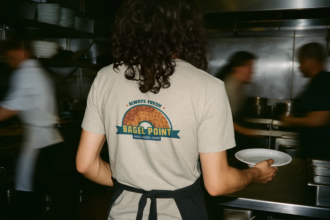 Staff t-shirt with Bagel Point back print, kitchen