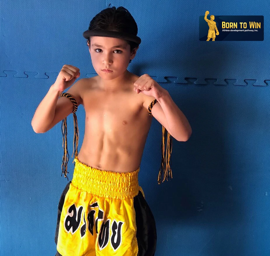 Young muay thai fighter in guard, plaque locked top-right