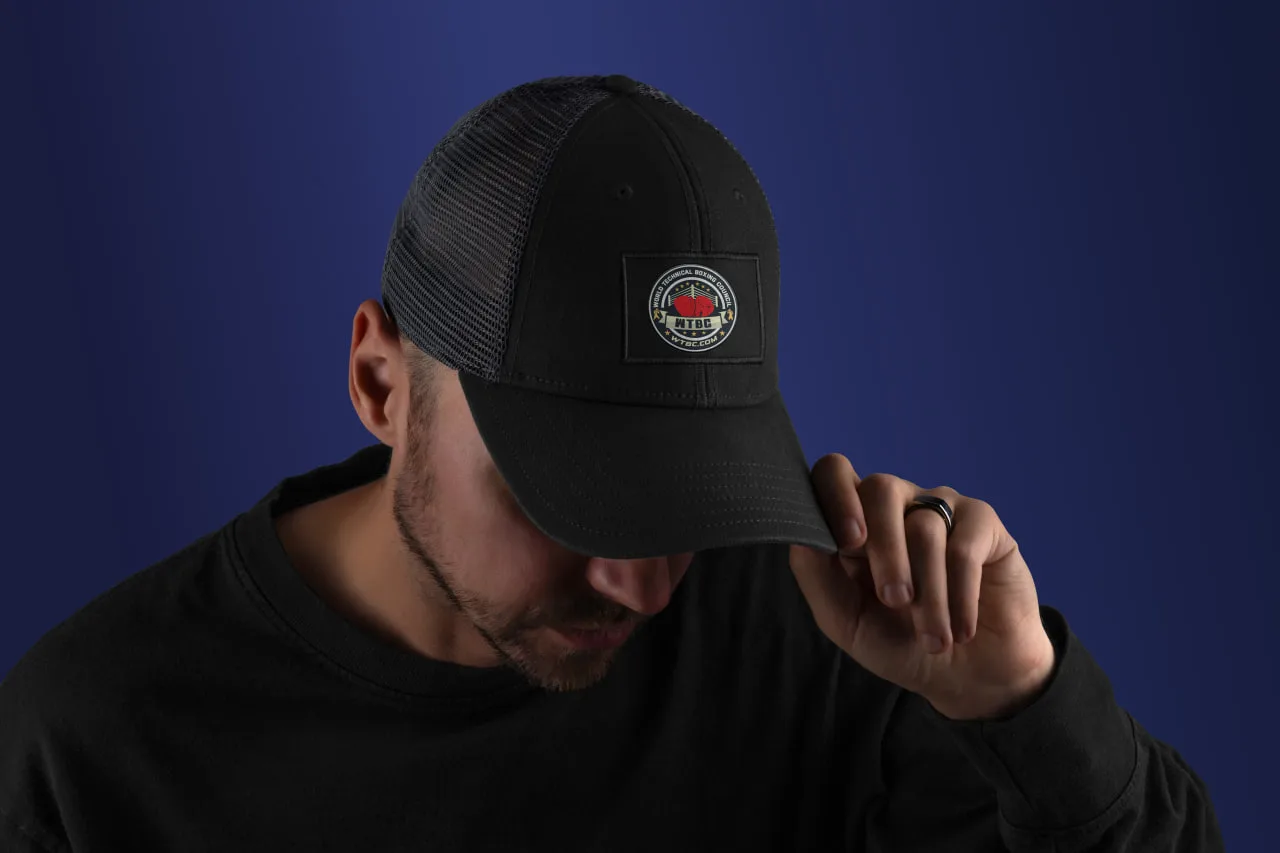 Woven WTBC patch on a black trucker cap